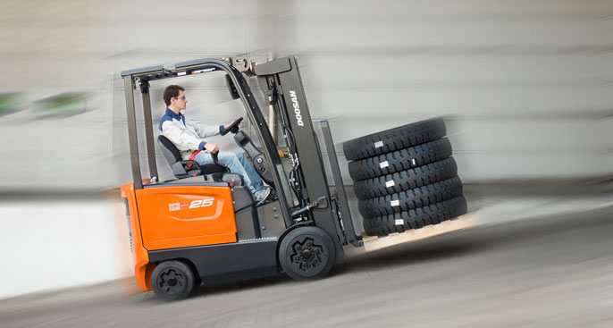 Man zooms by on forklift going uphill