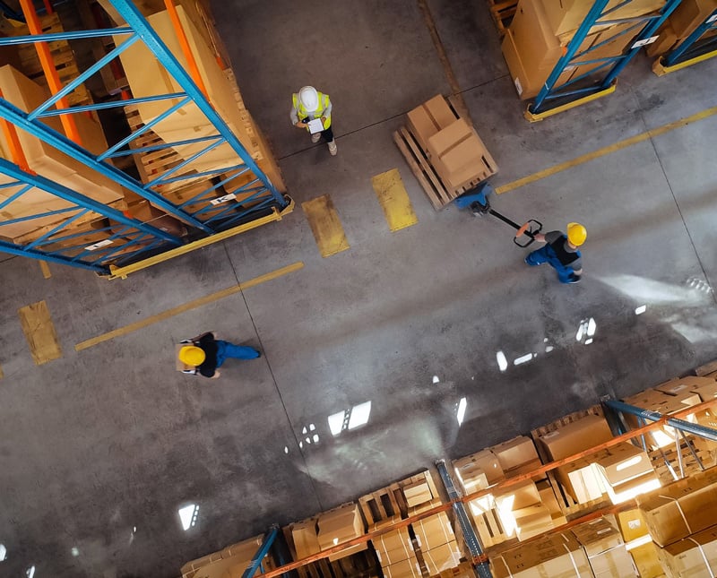 Busy Warehouse with Material Handling Equipment