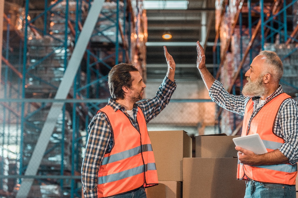 AdobeStock_177413270_Warehouse_Highfive_Hero_Color_1000px