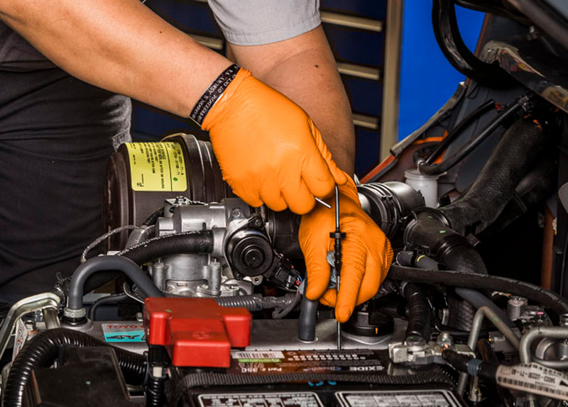 A Forklift Technician Servicing a Forklift